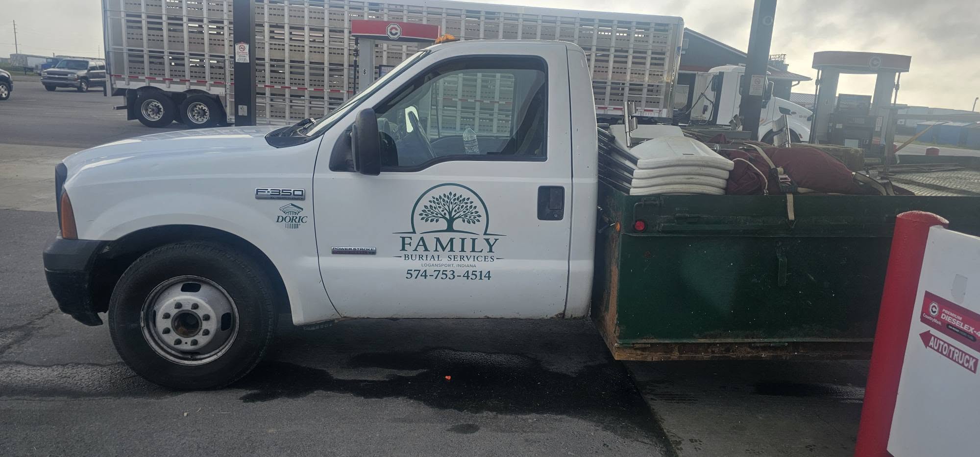 Family Burial Services F-350 service truck hauling graveside equipment